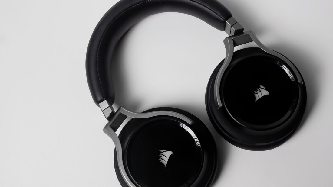 Black over-ear wireless headphones on a light background.